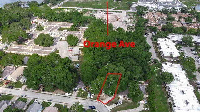 an aerial view of residential house with outdoor space and trees all around