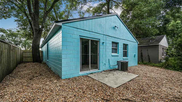 a view of a small house with a yard