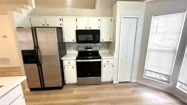 a kitchen with a refrigerator stove and a sink