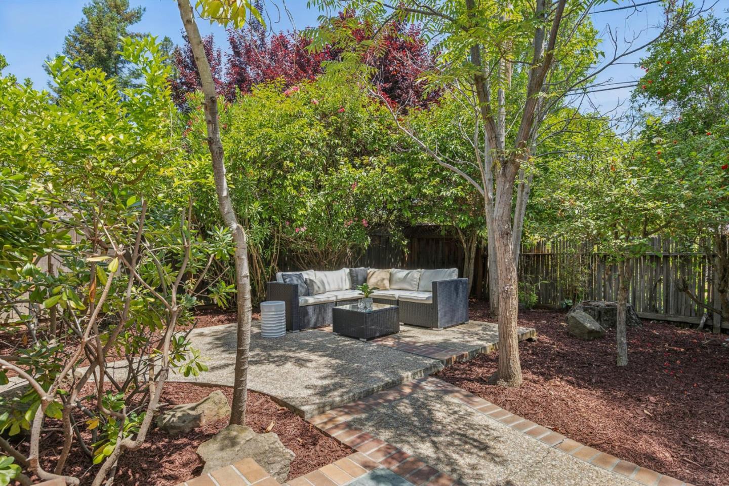 755 Santa Rita Avenue Los Altos, CA 94022 - Photo 48 of 50 a view of a backyard with table and chairs potted plants and large tree