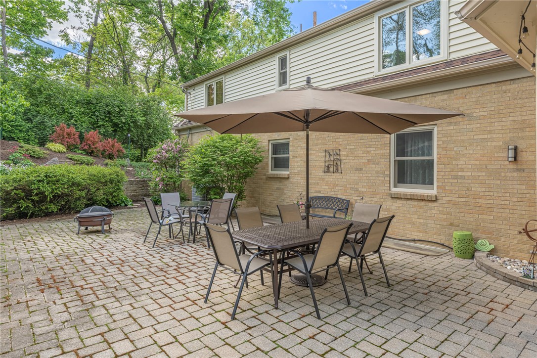 156 West Hadley Road Dayton, OH 45419 - Photo 48 of 71 This spacious outdoor patio features brick pavers and a vibrant garden, perfect for relaxation or entertaining.