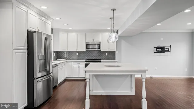 a kitchen with stainless steel appliances a refrigerator sink and microwave