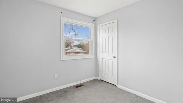 a view of room with window and hallway