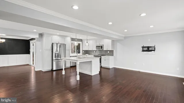 a view of kitchen with stainless steel appliances refrigerator oven and cabinets