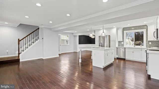 a view of kitchen with cabinets and wooden floor