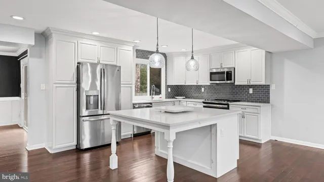 a kitchen with stainless steel appliances a microwave a sink and a refrigerator