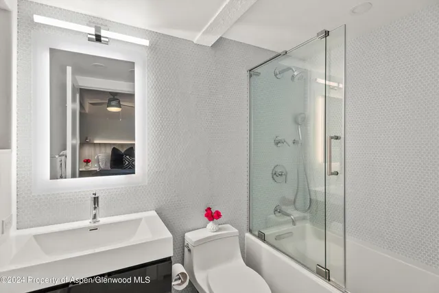 a bathroom with a sink toilet and shower