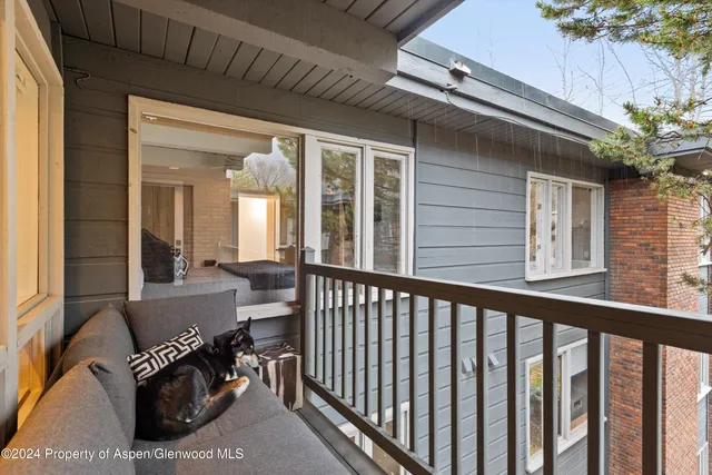 a view of a porch with furniture and a gate