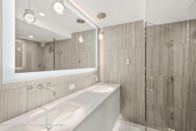 a bathroom with a double vanity sink and a mirror