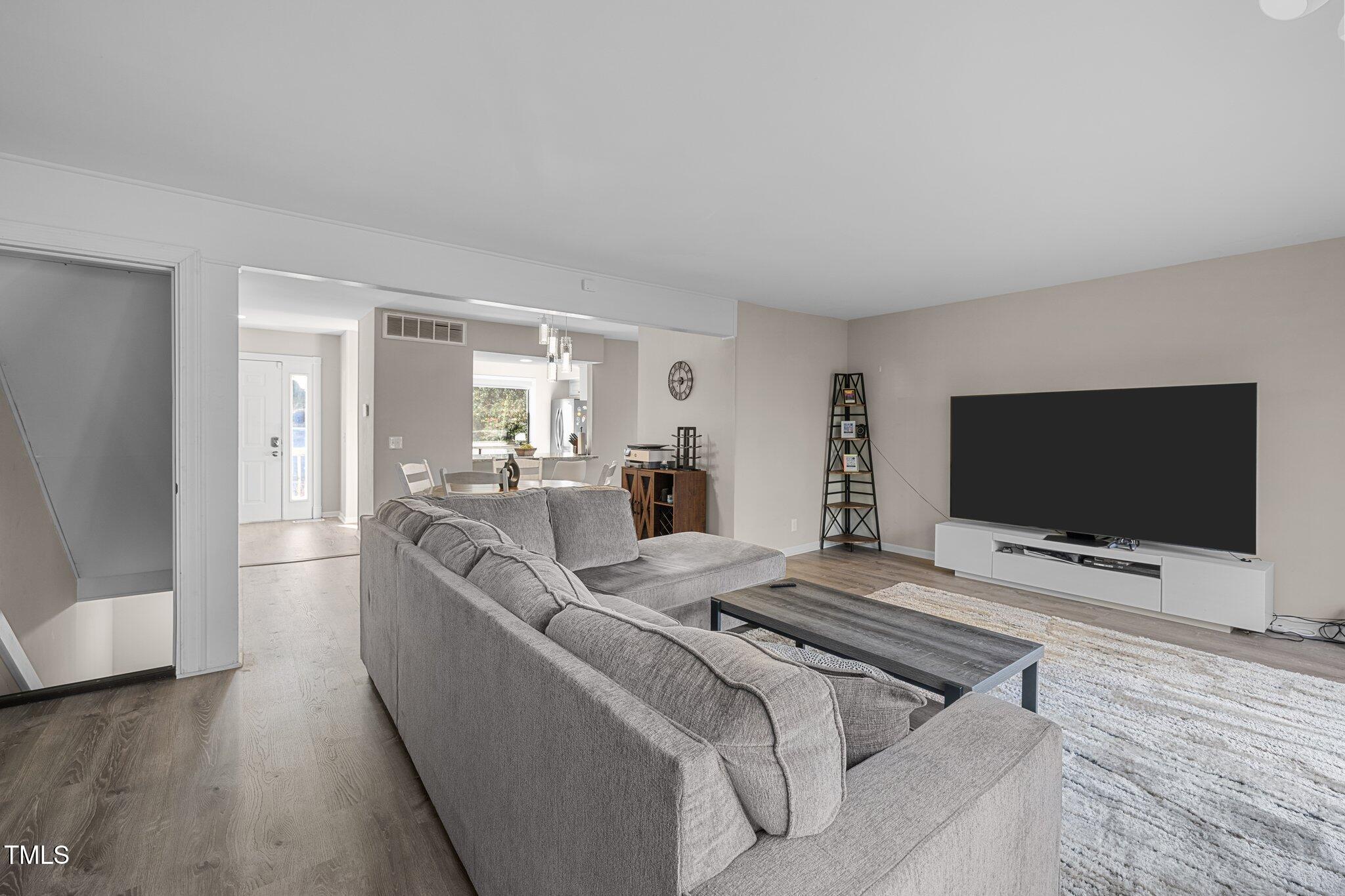 6230 Dixon Drive Raleigh, NC 27609 - Photo 12 of 32 a living room with furniture and a flat screen tv