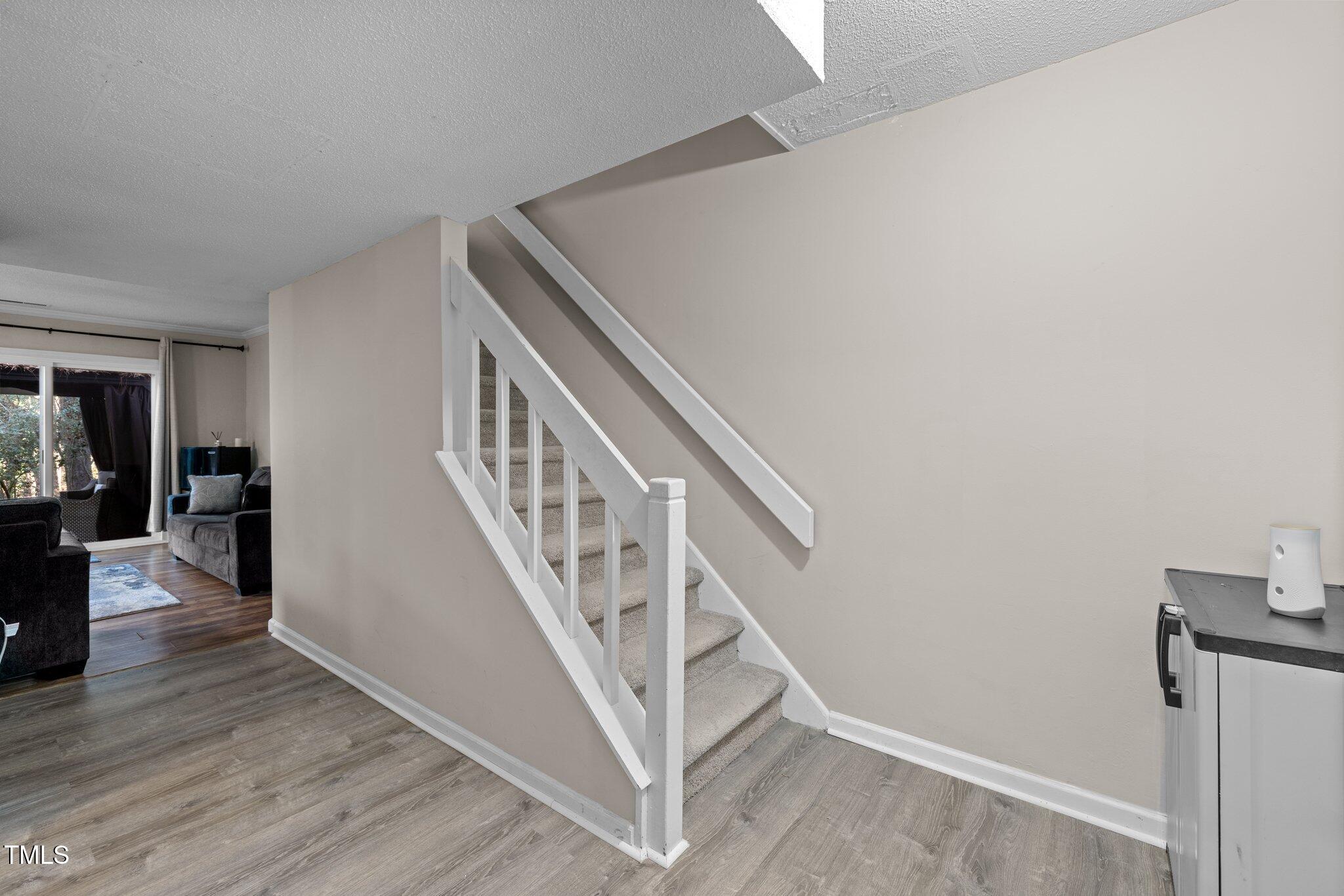 6230 Dixon Drive Raleigh, NC 27609 - Photo 13 of 32 a view of entryway and hall with wooden floor