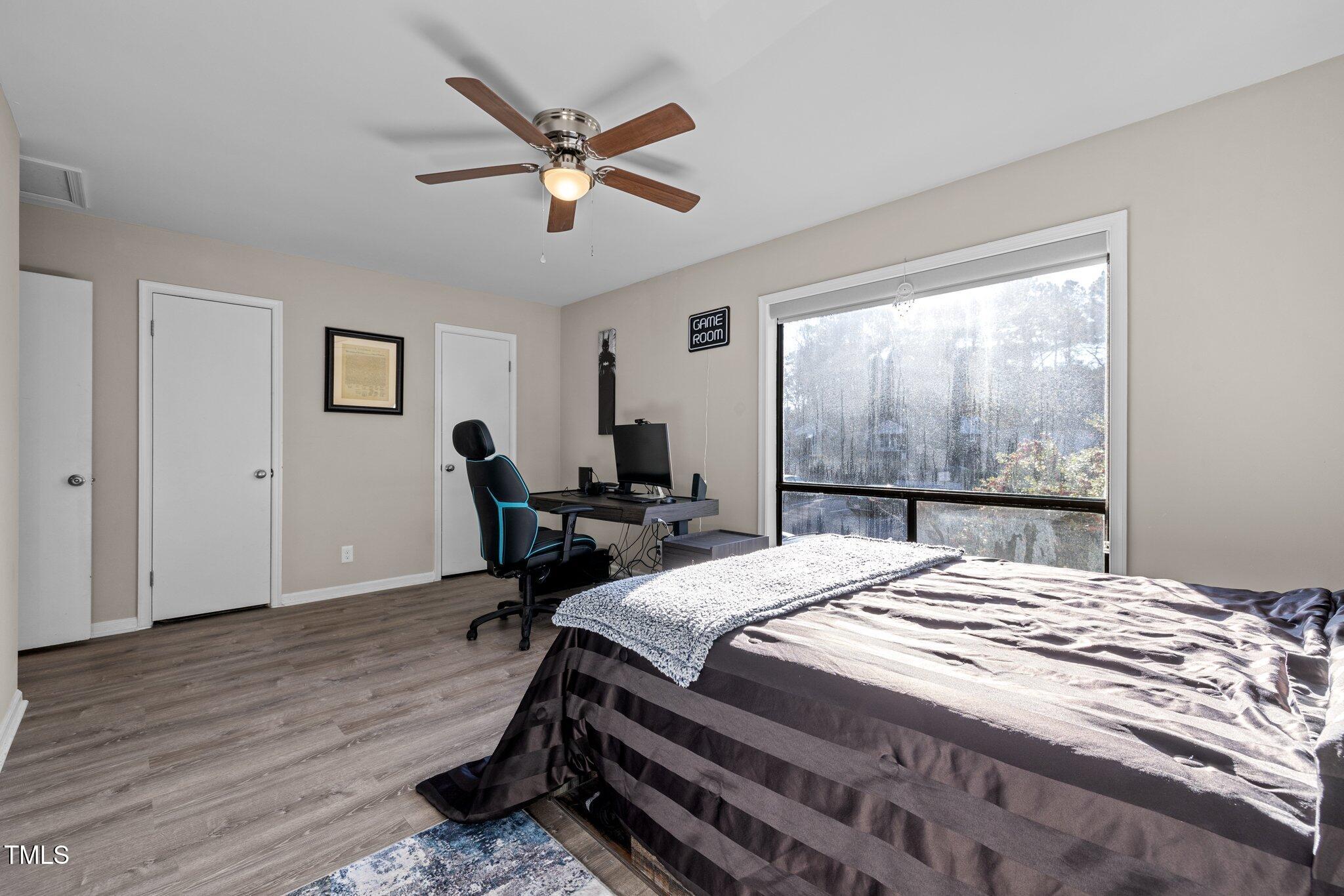 6230 Dixon Drive Raleigh, NC 27609 - Photo 24 of 32 a bed sitting in a bedroom next to a window