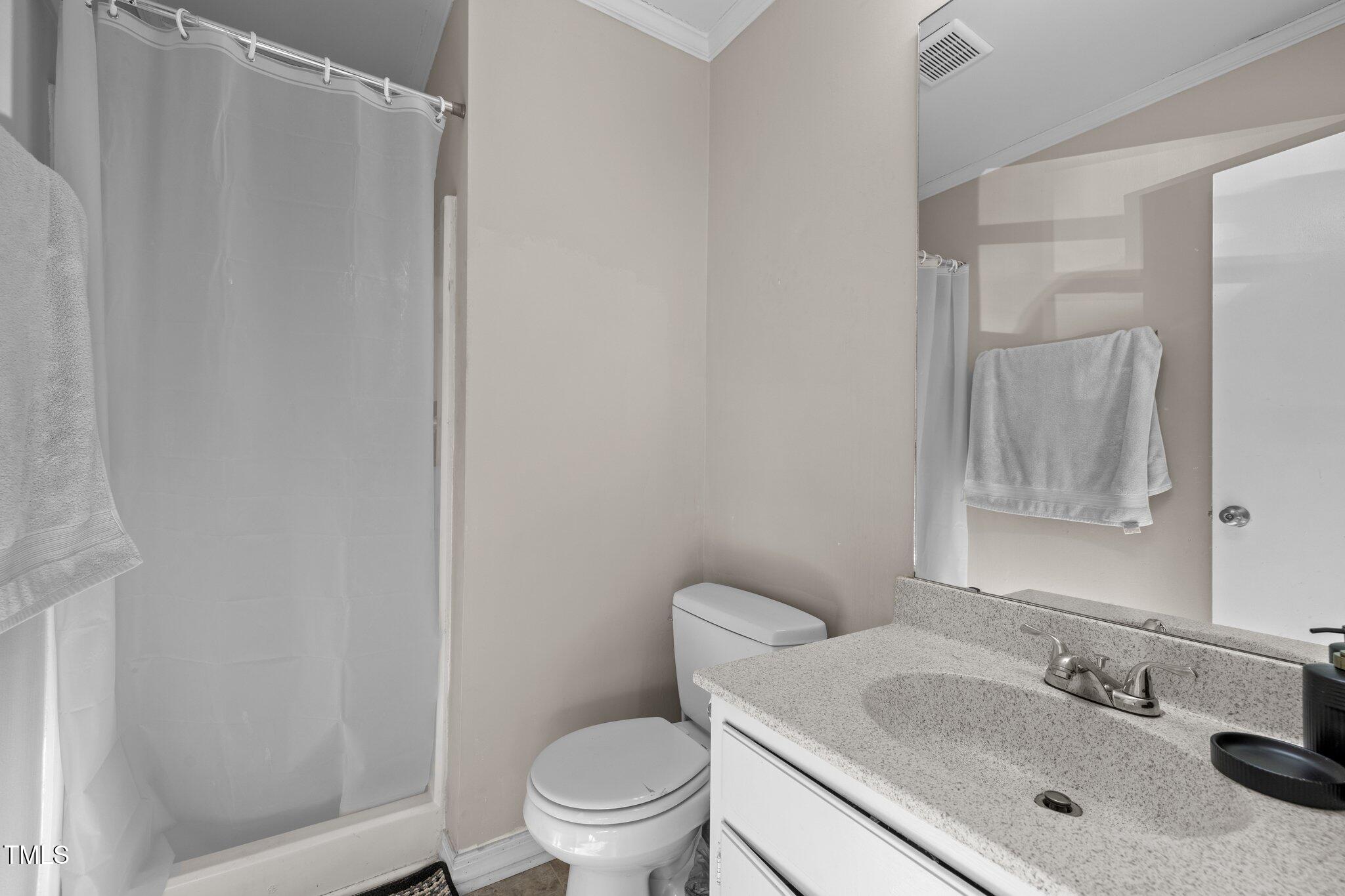 6230 Dixon Drive Raleigh, NC 27609 - Photo 25 of 32 a bathroom with a sink toilet and mirror