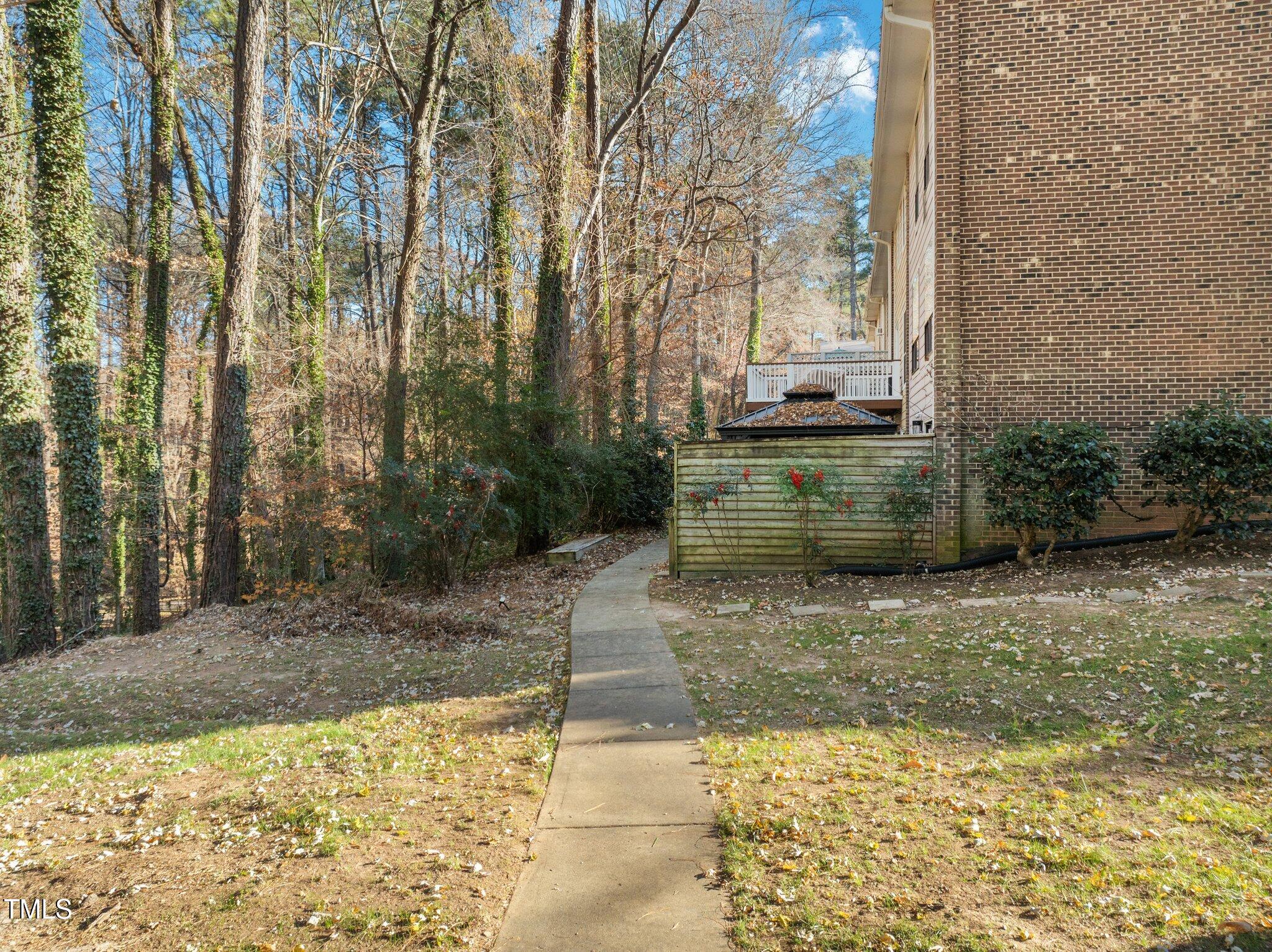 6230 Dixon Drive Raleigh, NC 27609 - Photo 29 of 32 a view of a pathway both side of the house
