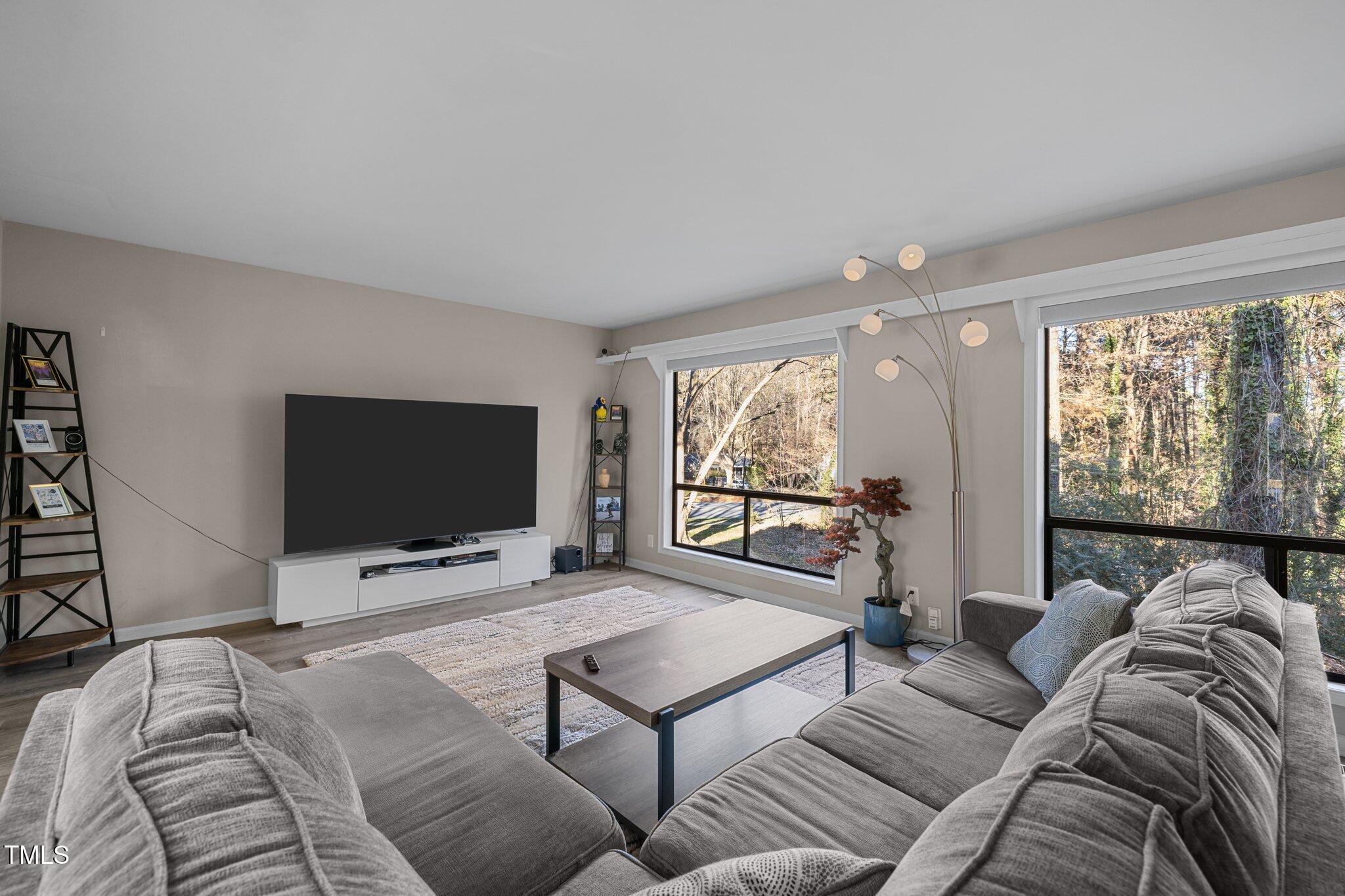 6230 Dixon Drive Raleigh, NC 27609 - Photo 9 of 32 a living room with furniture and a flat screen tv