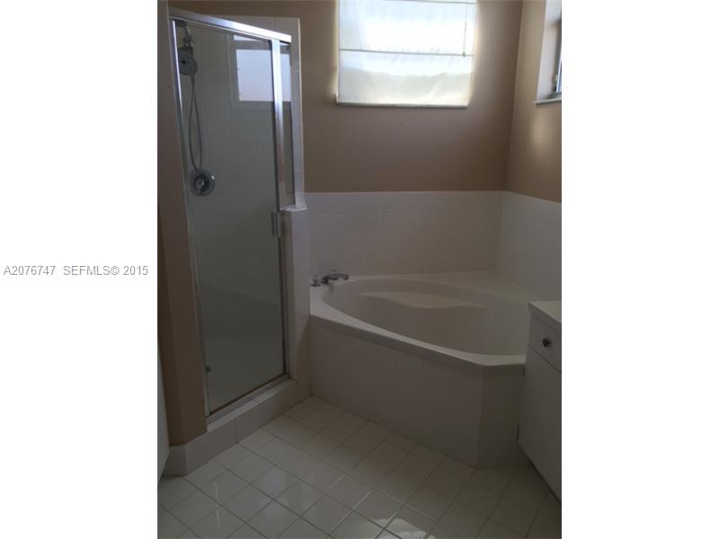 2145 Northeast 38th Road Homestead, FL 33033 - Photo 19 of 28 a white bath tub sitting next to a window