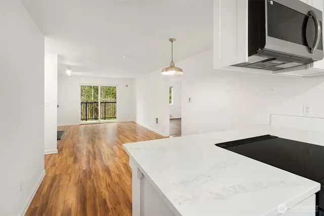 a kitchen with a wooden floor and a window