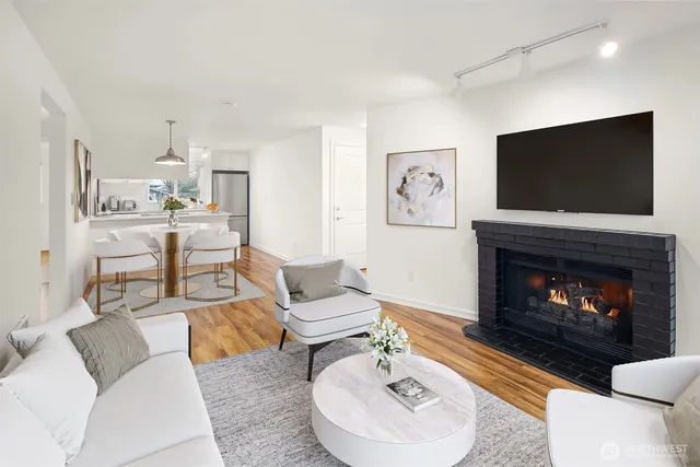 a living room with furniture a flat screen tv and a fireplace