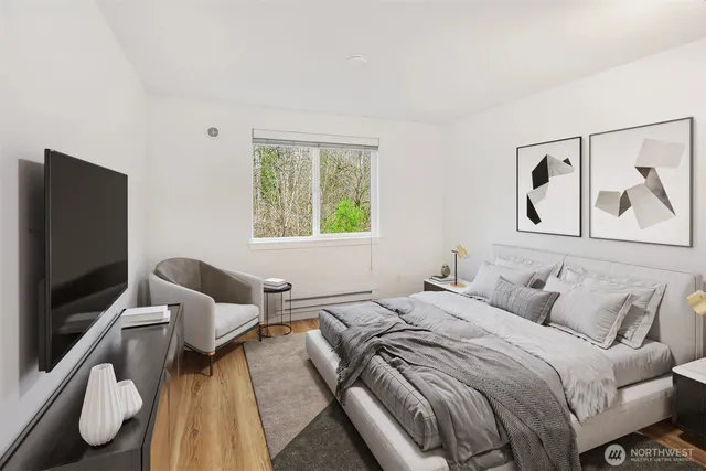 a bedroom with a bed and a flat screen tv