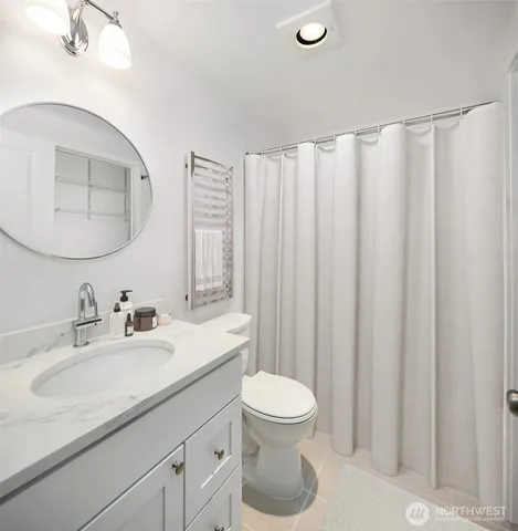 a bathroom with a granite countertop sink a toilet and bathtub