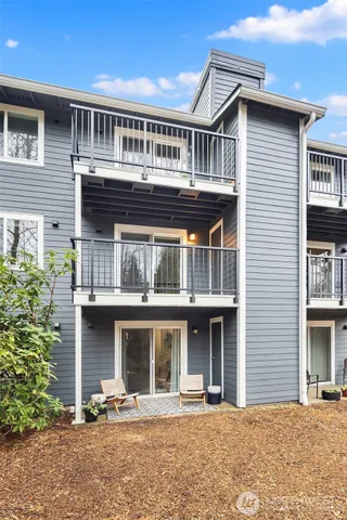 a front view of a house with yard and seating space