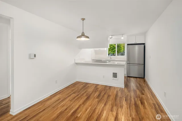 a kitchen with a wooden floor and a window