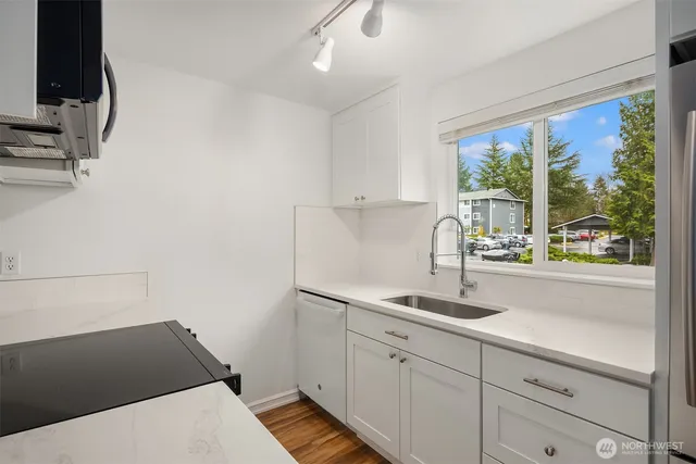 a kitchen with a sink and large window