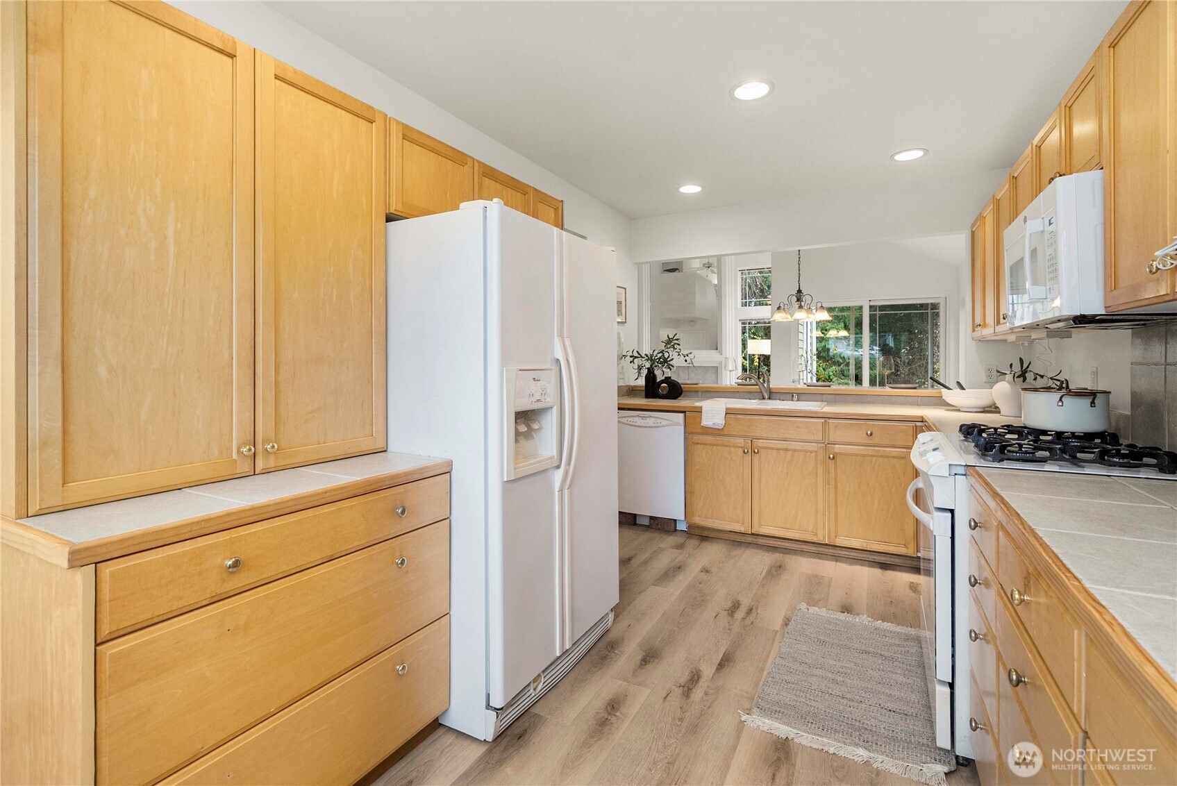 19504 Southeast 24th, Unit B Bothell, WA 98012 - Photo 11 of 34 a kitchen with white cabinets and white appliances