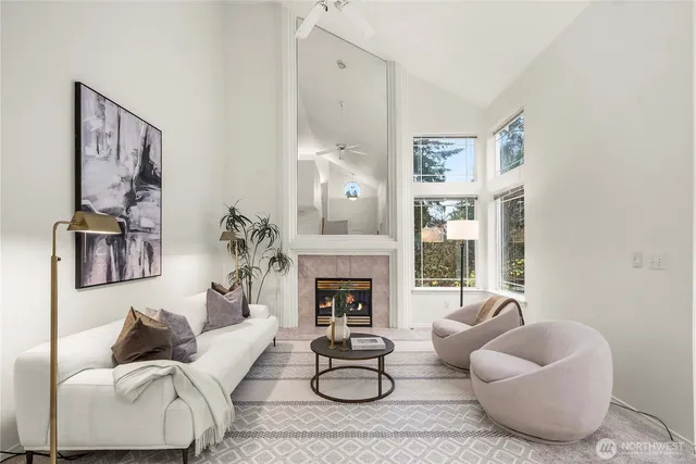 a living room with furniture fireplace and a window