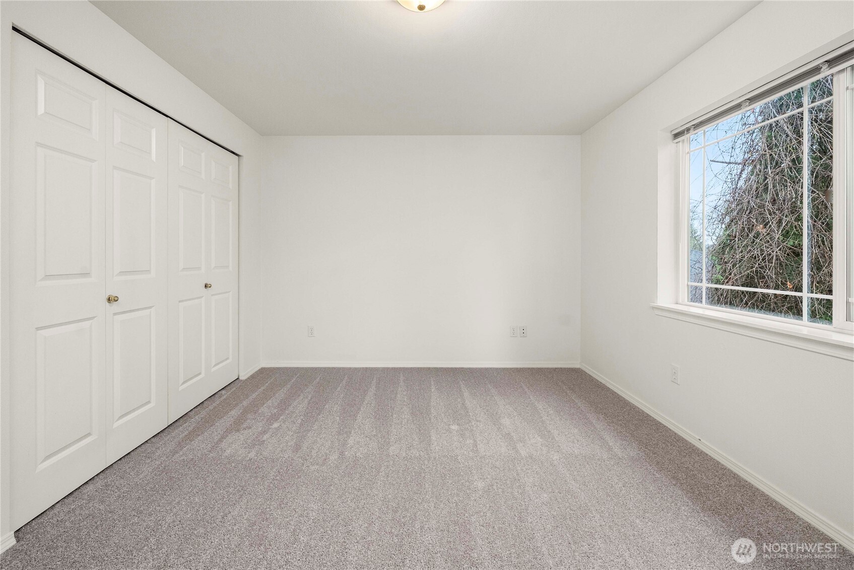 19504 Southeast 24th, Unit B Bothell, WA 98012 - Photo 23 of 34 a view of an empty room with a window and hardwood floor