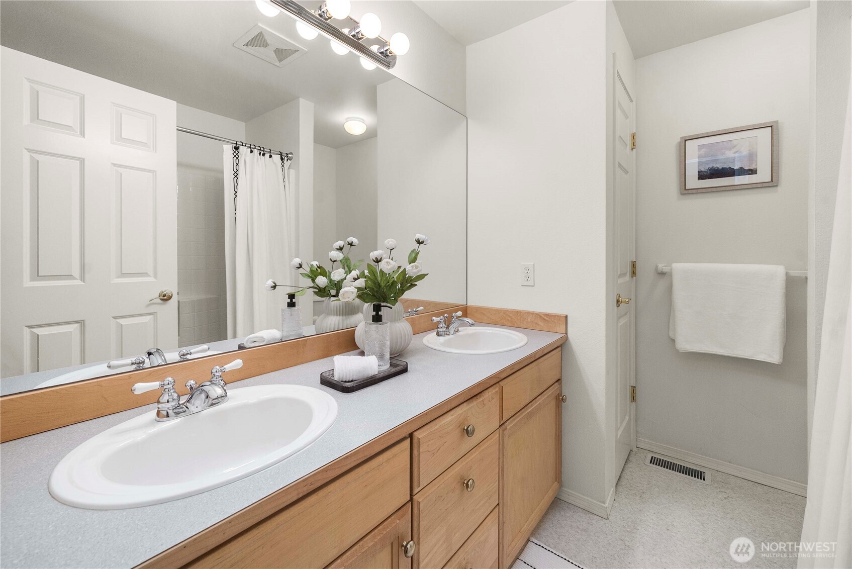 19504 Southeast 24th, Unit B Bothell, WA 98012 - Photo 24 of 34 a bathroom with a sink double vanity and a mirror
