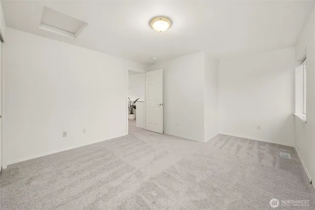 an empty room with a empty space and a window