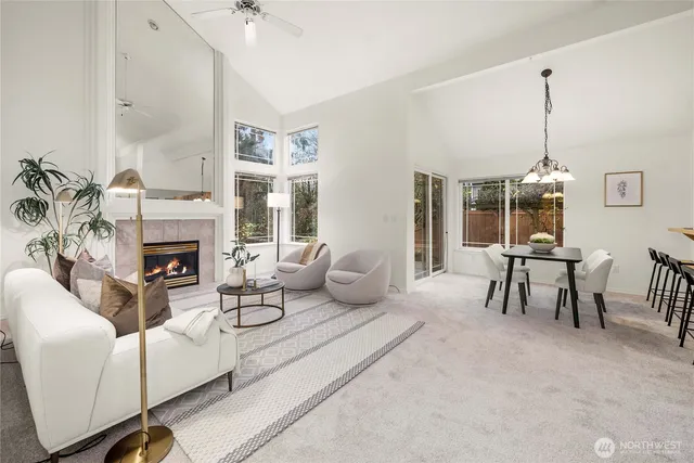 a living room with furniture a fireplace and a chandelier