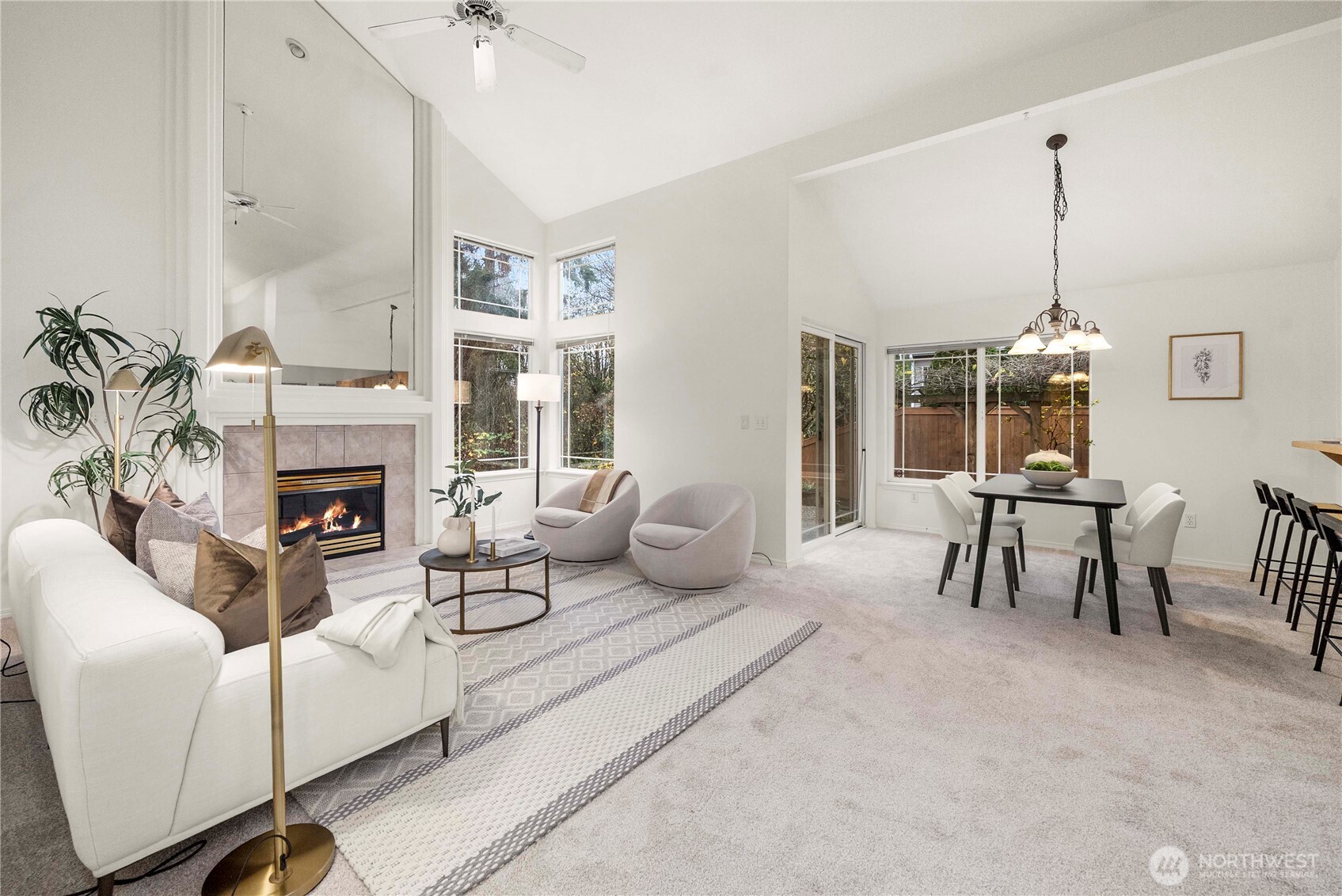 19504 Southeast 24th, Unit B Bothell, WA 98012 - Photo 5 of 34 a living room with furniture a fireplace and a chandelier