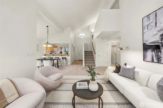 a living room with furniture and kitchen view