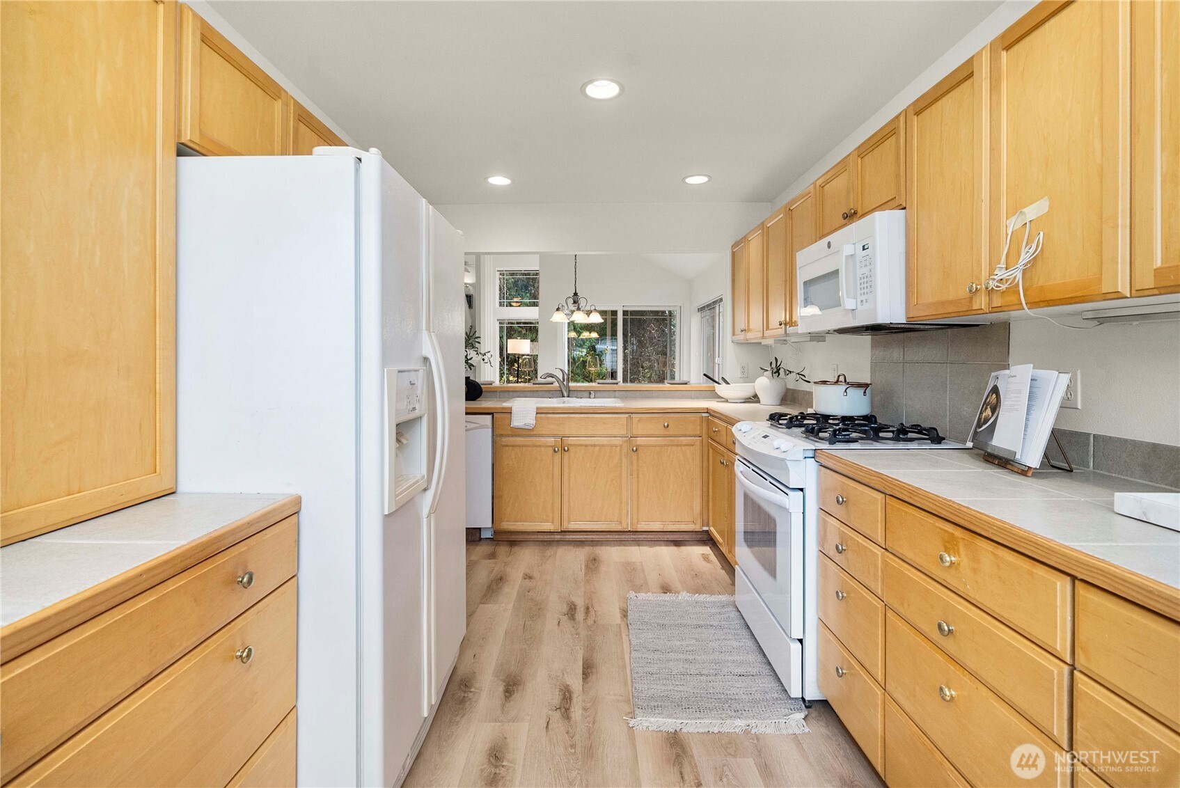 19504 Southeast 24th, Unit B Bothell, WA 98012 - Photo 10 of 34 a kitchen with stainless steel appliances granite countertop a refrigerator sink and white cabinets