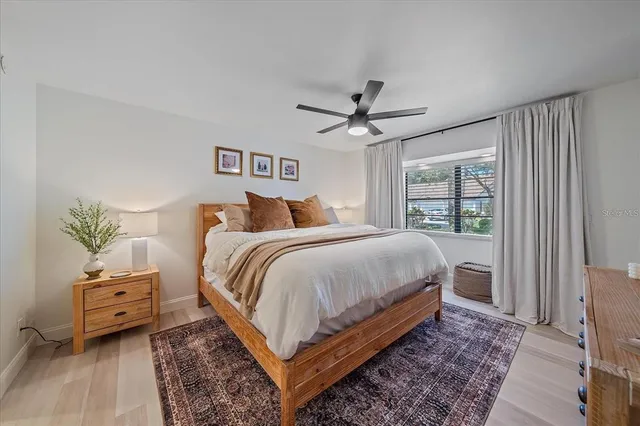 a bedroom with a large bed and a window