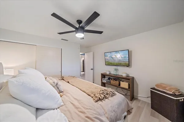 a bedroom with a bed and a chandelier