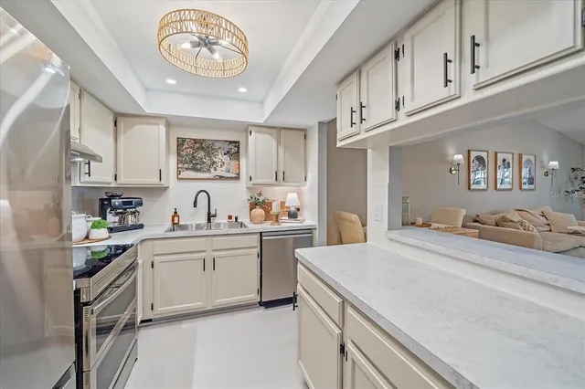 a kitchen with a sink cabinets and window