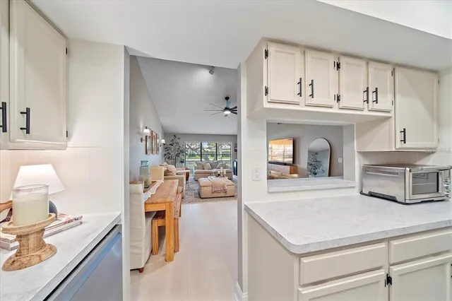 a view of kitchen with sink and living room