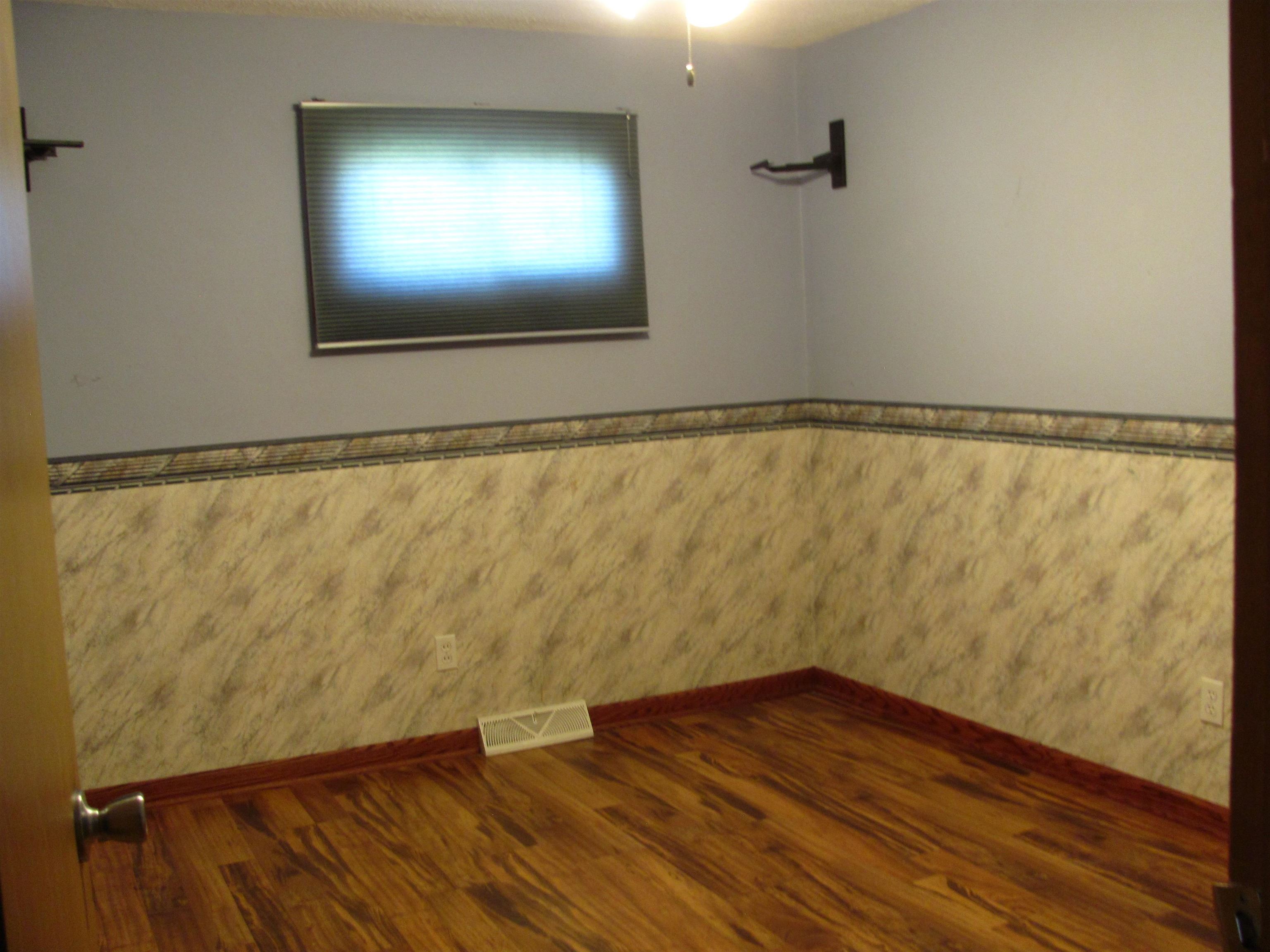 6159 Prairie Road Rockford, IL 61102 - Photo 24 of 47 a view of an empty room with wooden floor and a window