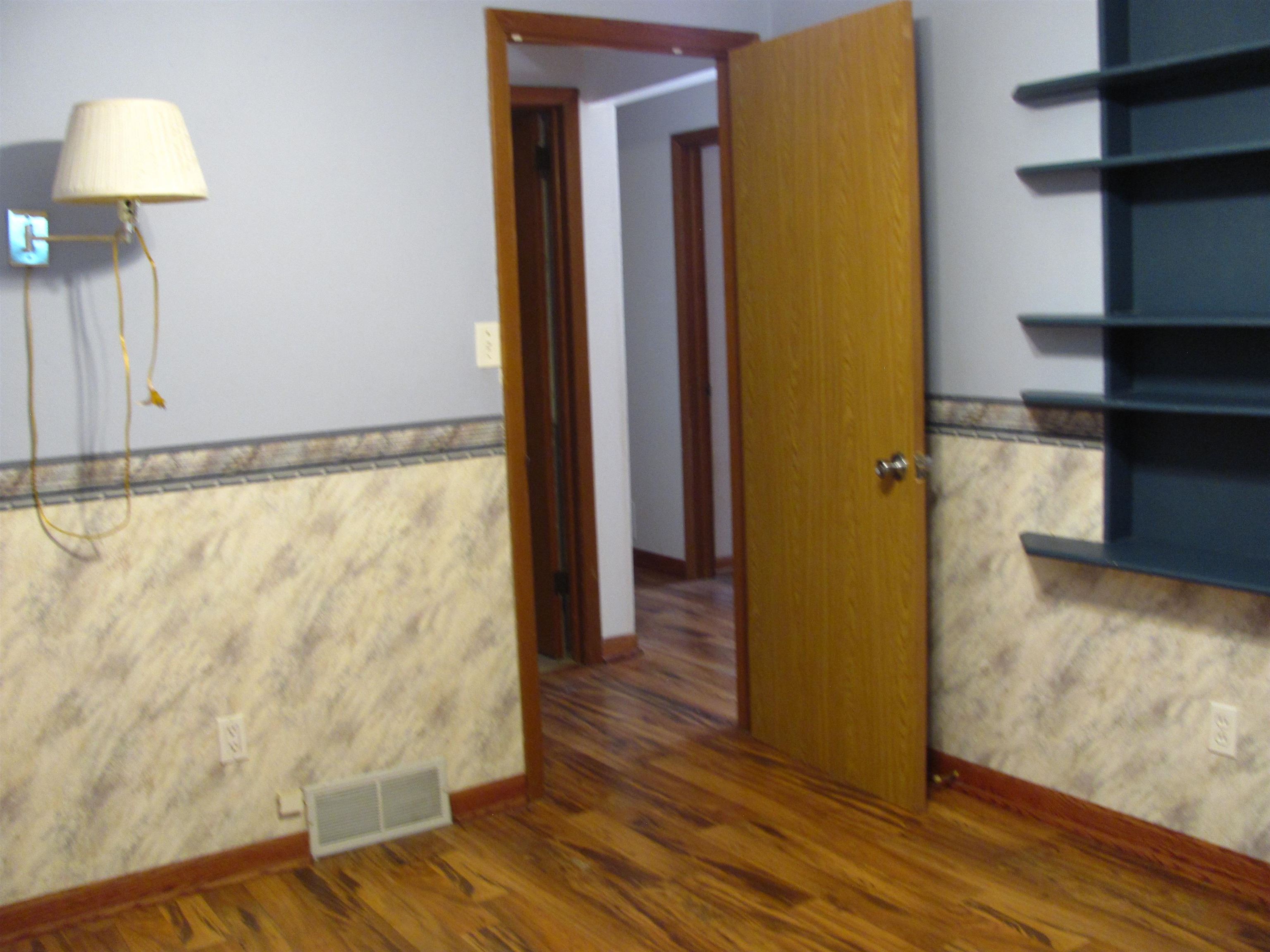 6159 Prairie Road Rockford, IL 61102 - Photo 25 of 47 a view of walk in closet with wooden floor
