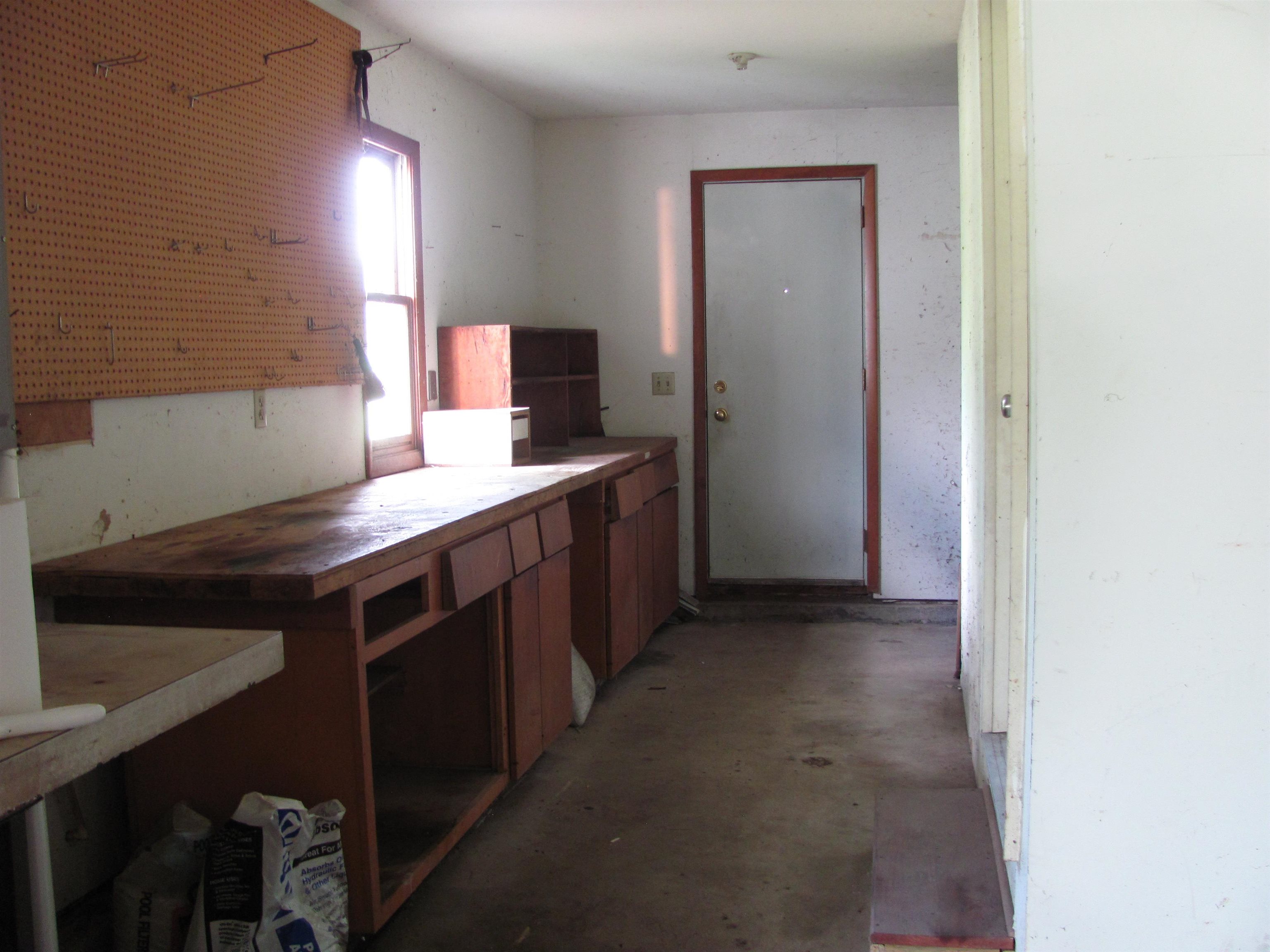 6159 Prairie Road Rockford, IL 61102 - Photo 38 of 47 a kitchen with a sink cabinets and a wooden floor