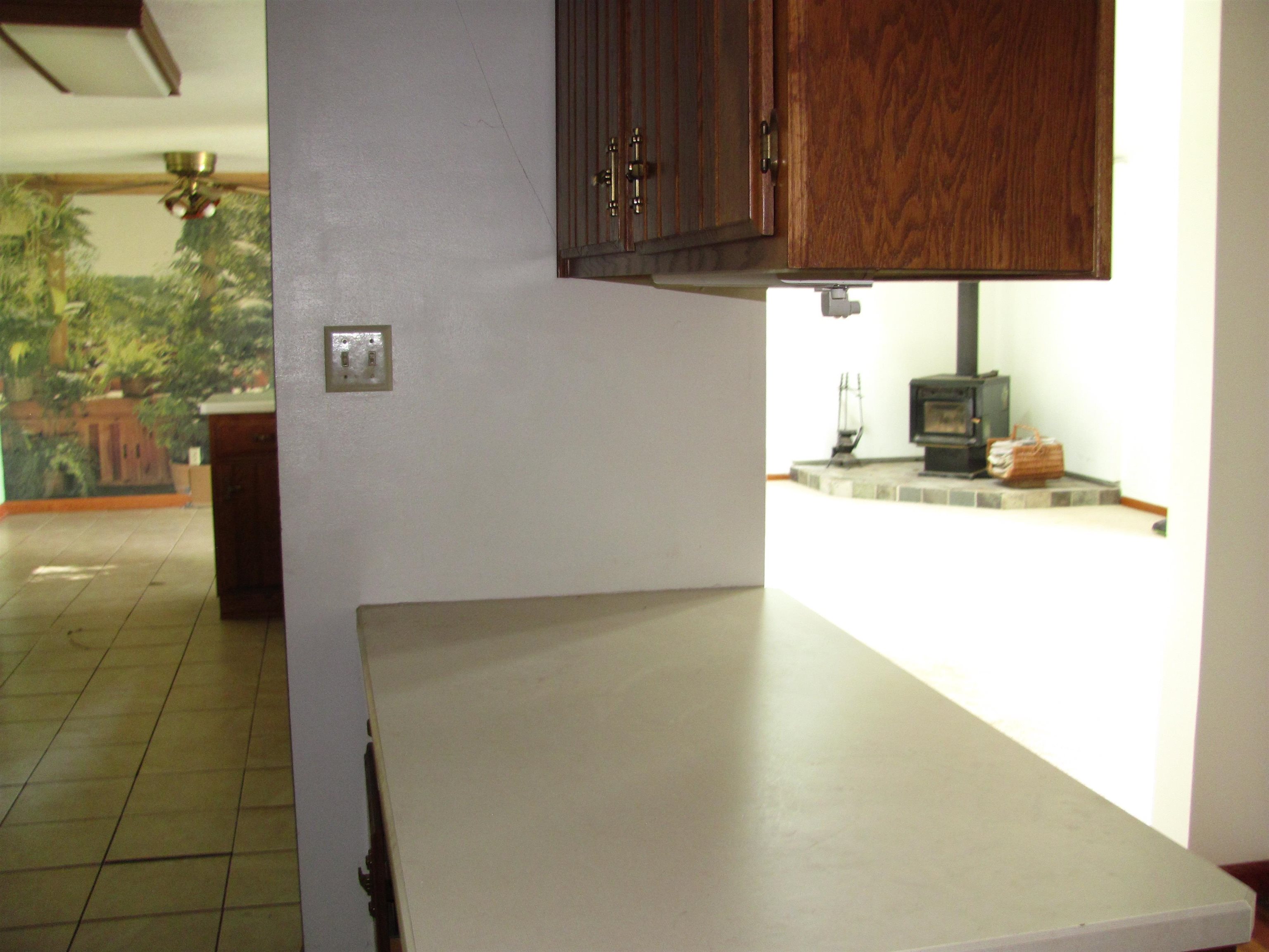 6159 Prairie Road Rockford, IL 61102 - Photo 5 of 47 a kitchen with a sink a stove and a microwave oven in a counter