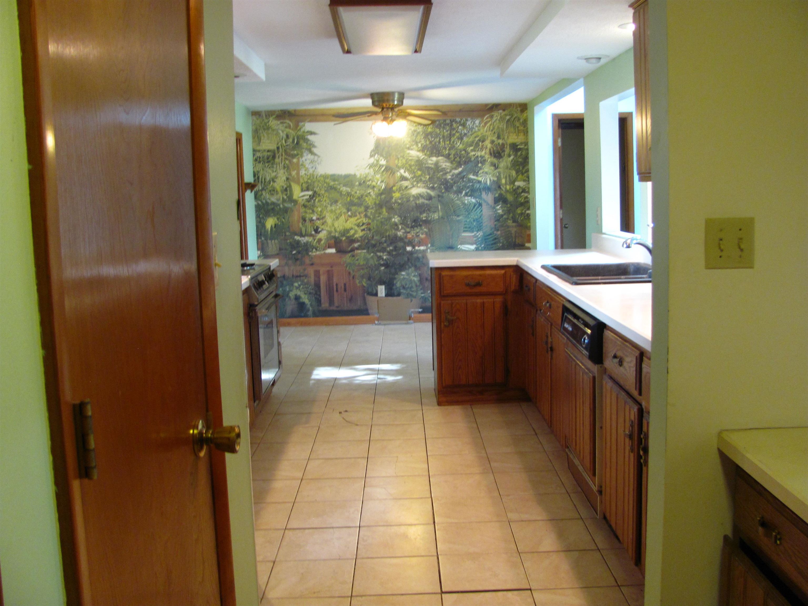 6159 Prairie Road Rockford, IL 61102 - Photo 10 of 47 a kitchen with stainless steel appliances granite countertop a refrigerator and a sink
