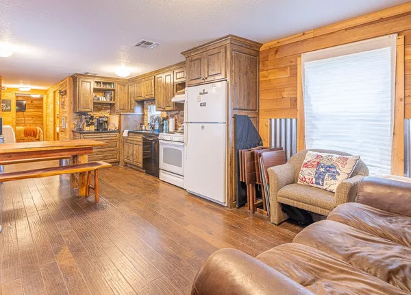 a view of kitchen with stainless steel appliances granite countertop a sink and cabinets