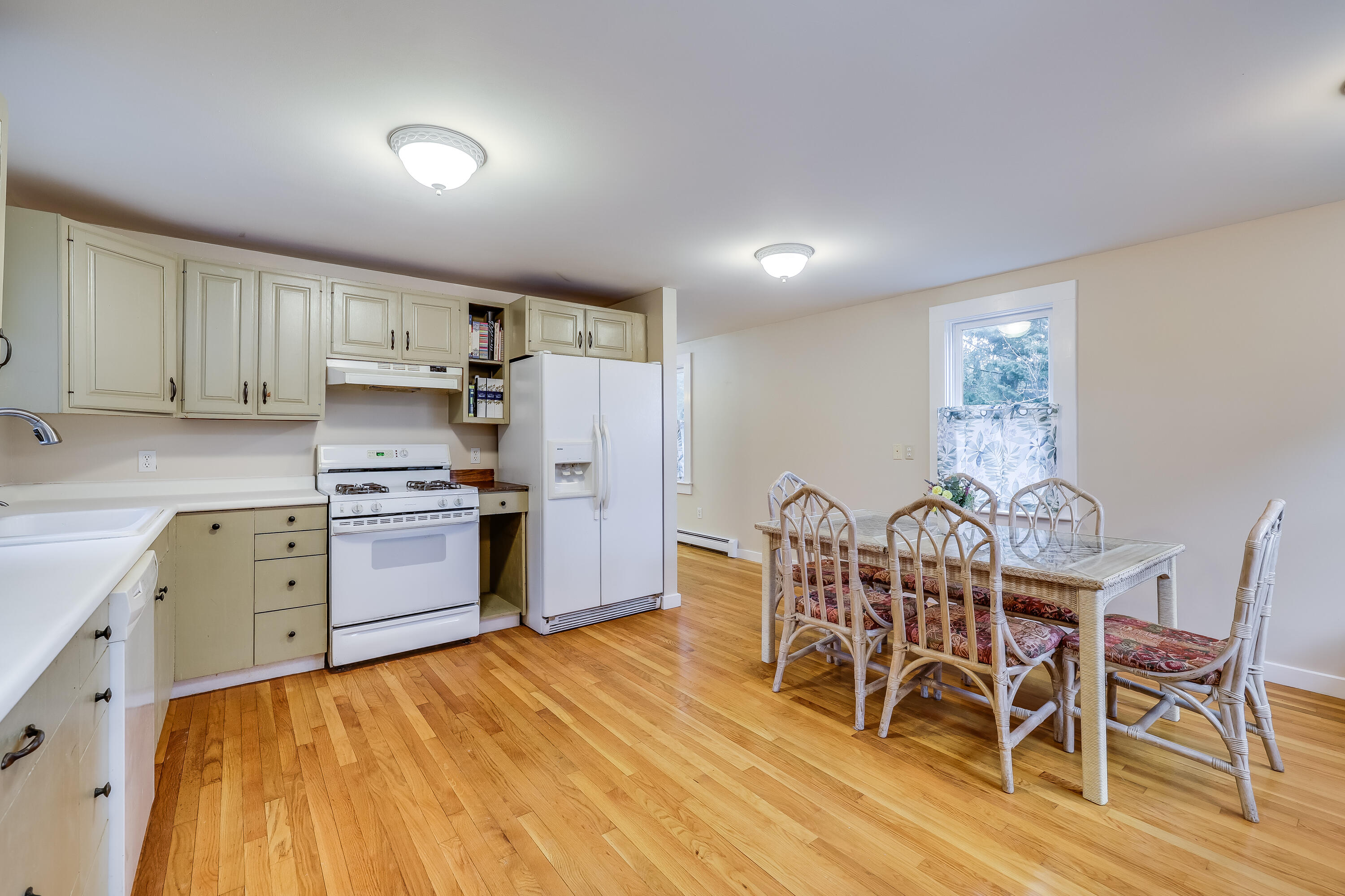 70 Shore Road Truro, MA 02666 - Photo 3 of 43 a kitchen with stainless steel appliances a table and chairs in it