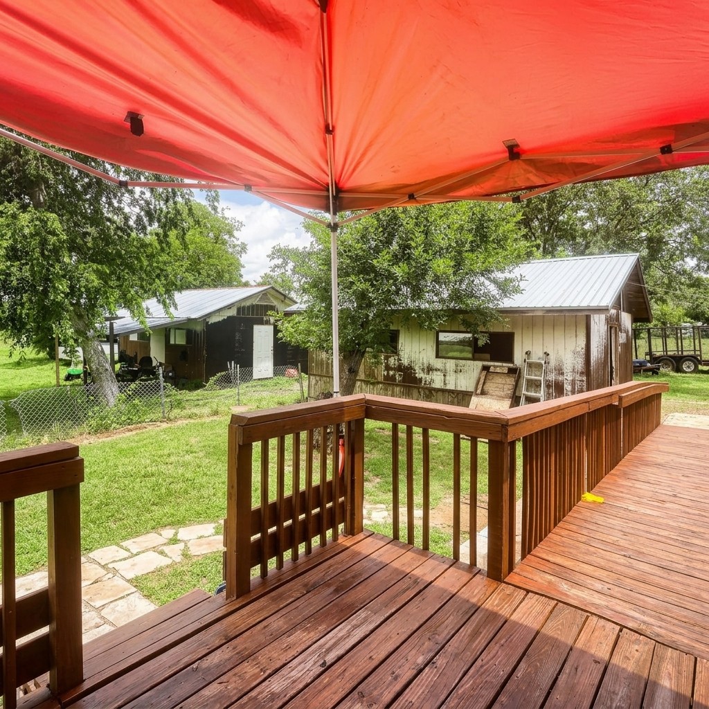 14520 Bois-D-Arc Road Manor, TX 78653 - Photo 11 of 21 a view of a wooden deck with a yard