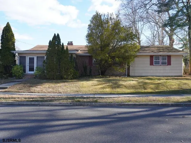 a view of swimming pool with a yard and large tree