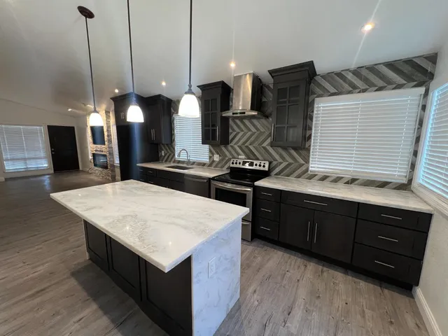a kitchen with a stove kitchen island and couches